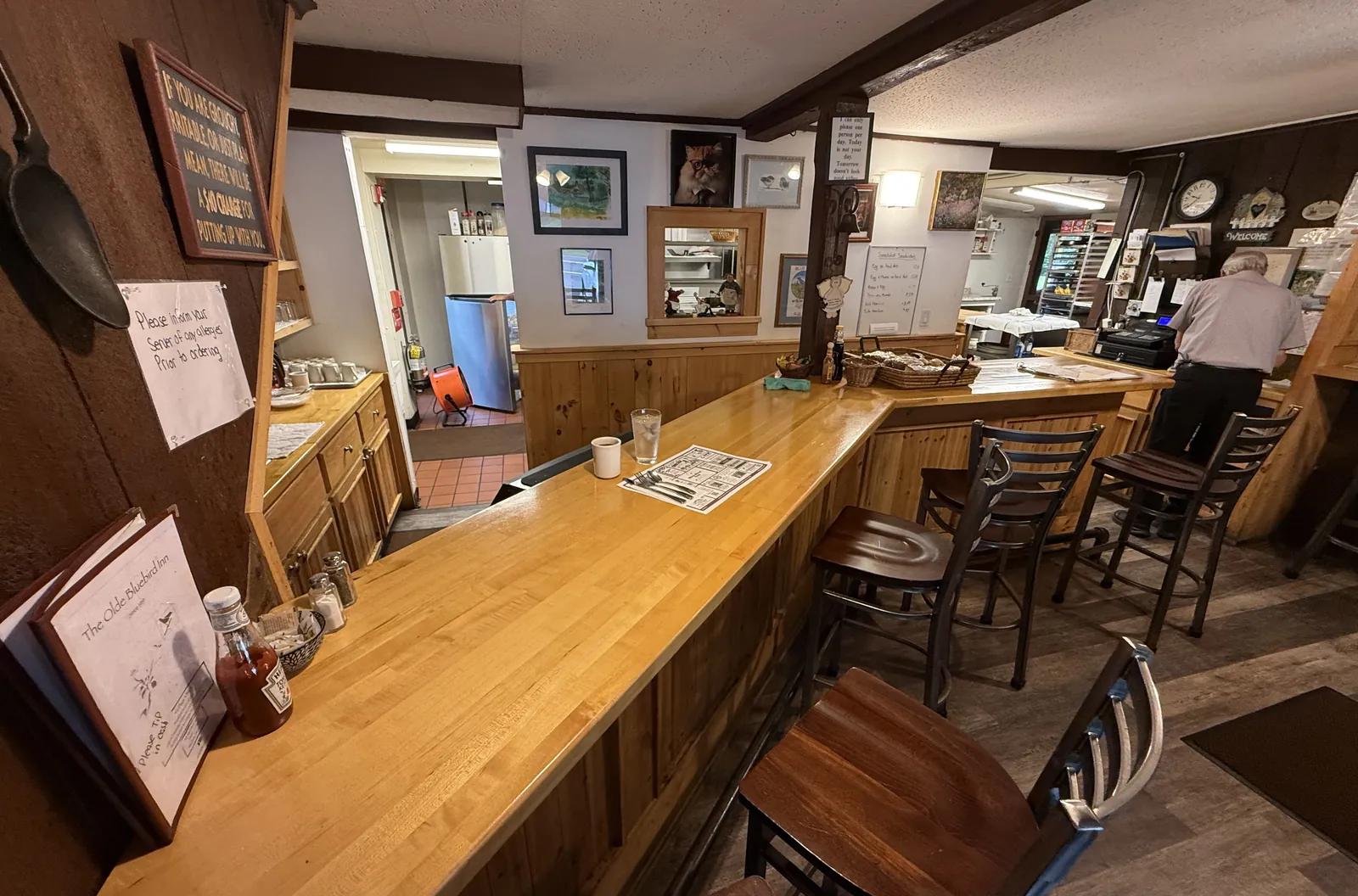 The long butcher-block lunch counter with stools, looking toward the kitchen